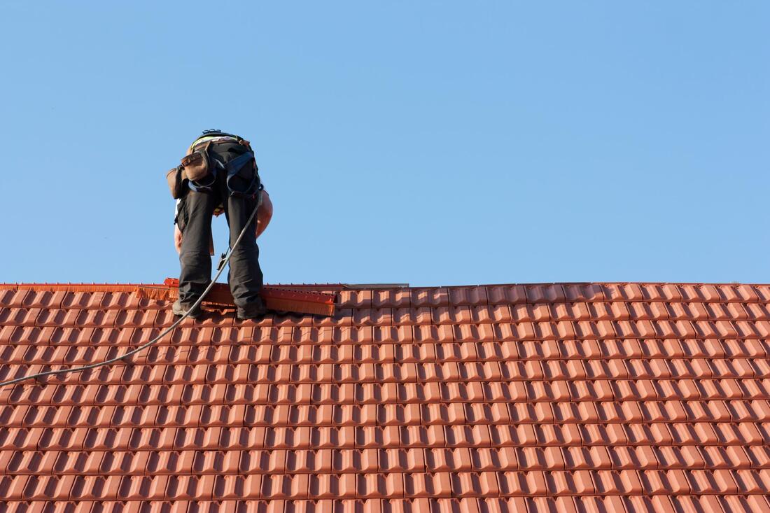professional roofer working on roof repair 